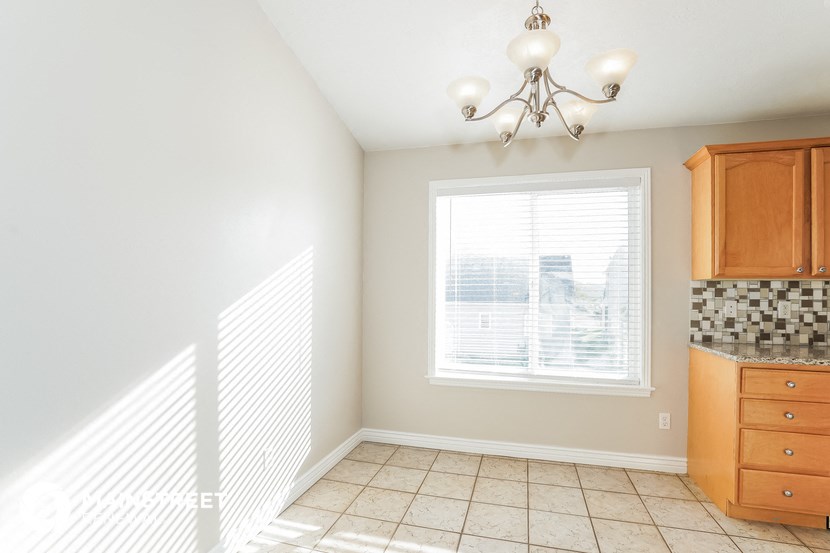 a kitchen with a window and a tiled floor