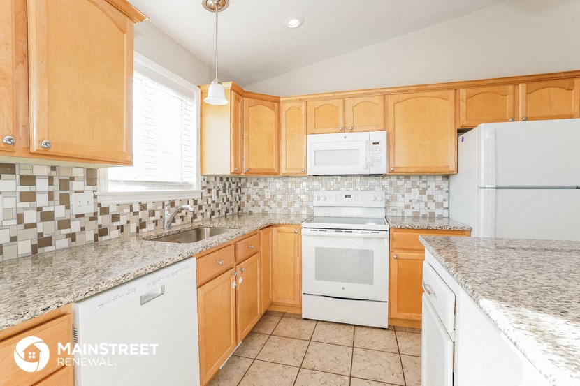 a kitchen with white appliances and granite counter tops