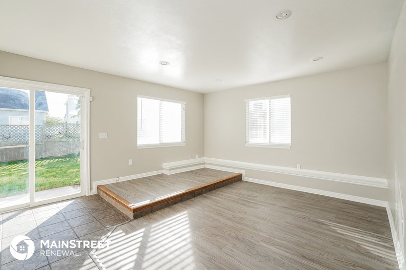 a living room with wood flooring and a sliding glass door