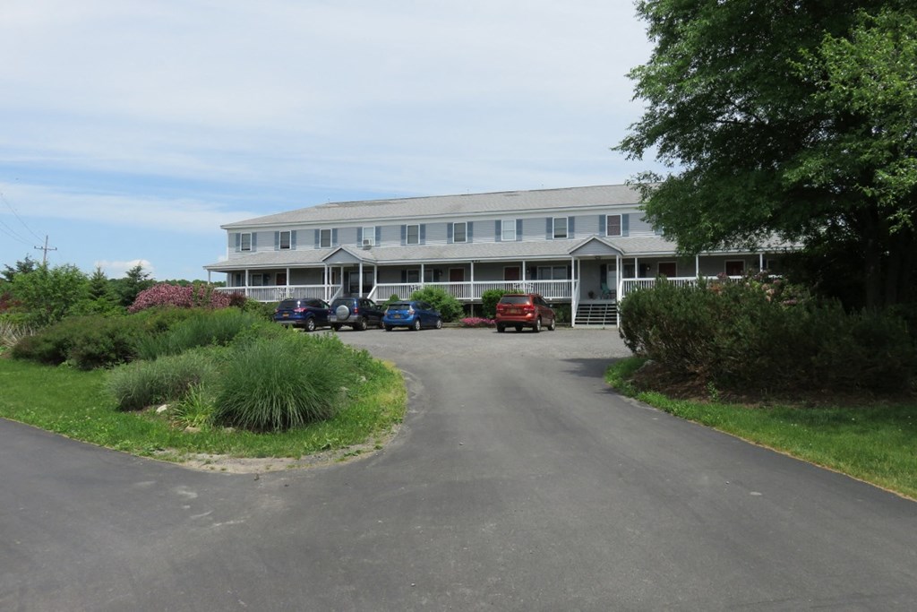 a large white building with cars parked in front of it
