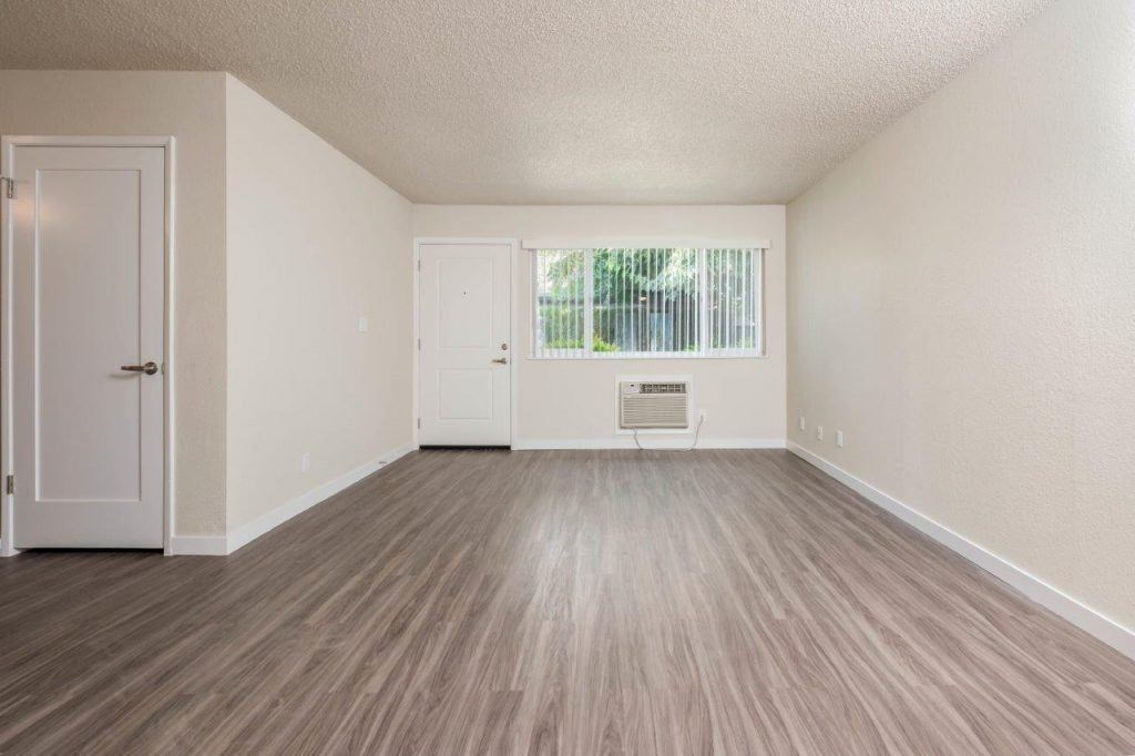View of living area with well lit entry at front entry