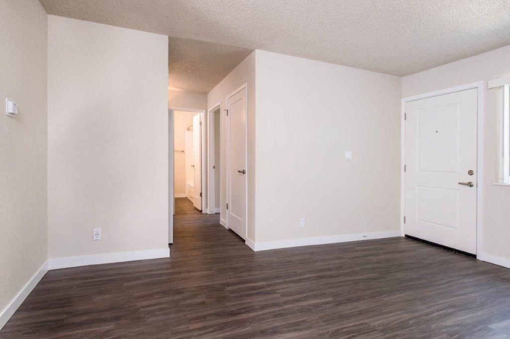 View down hallway from living area, with wood look flooring