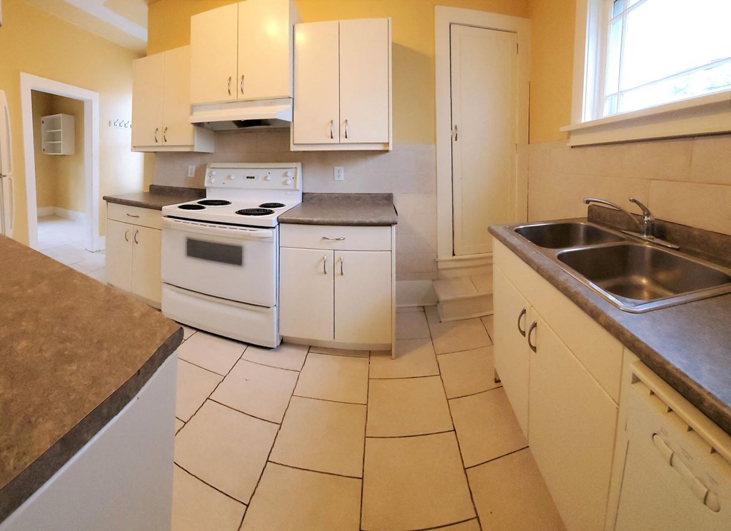 a kitchen with white appliances and white cabinets
