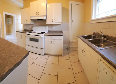 a kitchen with white appliances and white cabinets