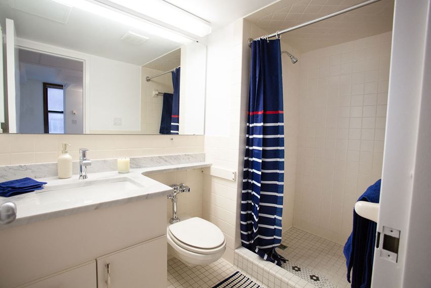 a bathroom with a toilet and a sink and a shower