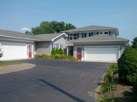 a house with a driveway and two garage doors