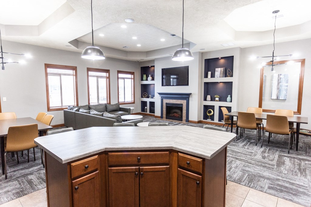 an open kitchen and living room with a table and chairs