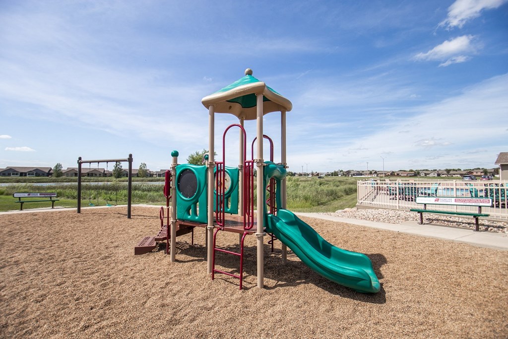 a playground with a slide and a swing set
