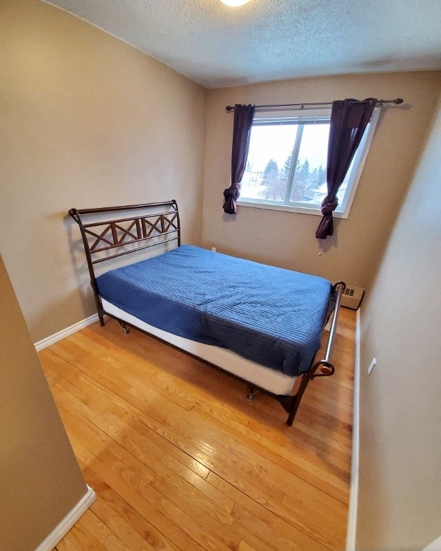 a small bedroom with a bed and a window