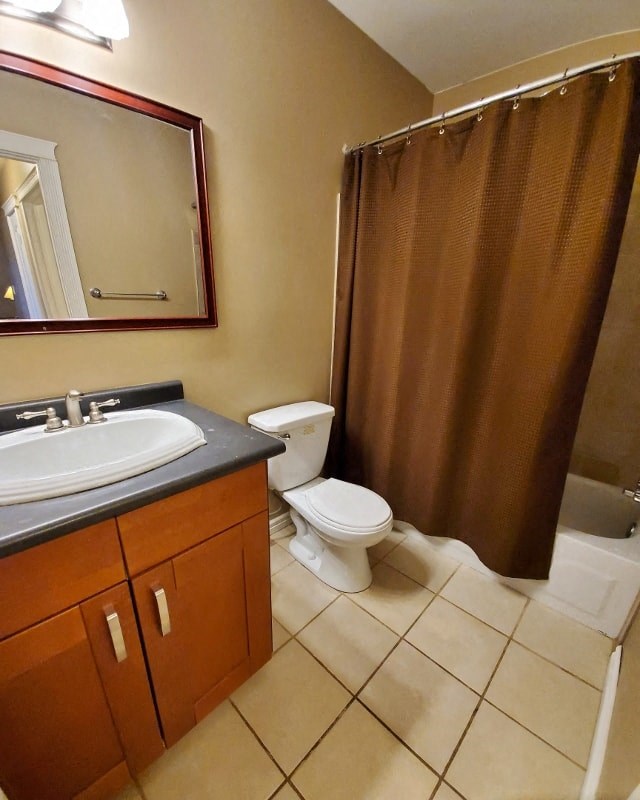a bathroom with a toilet and a sink and a shower