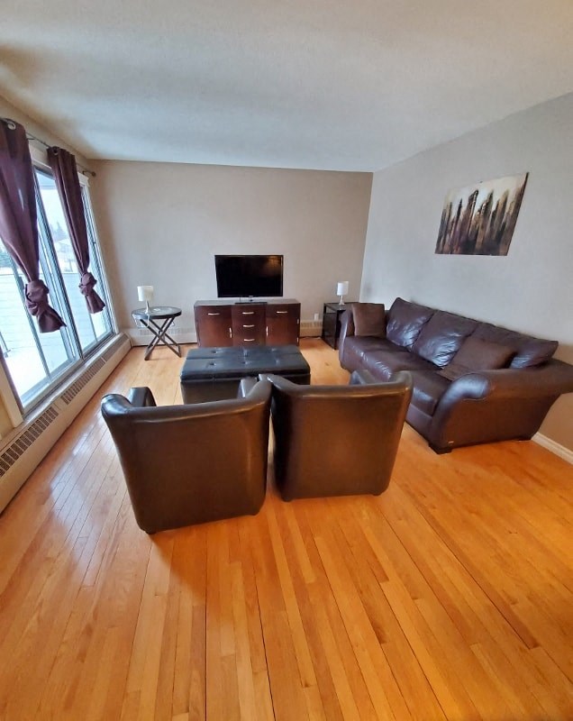 a living room with leather furniture and a tv