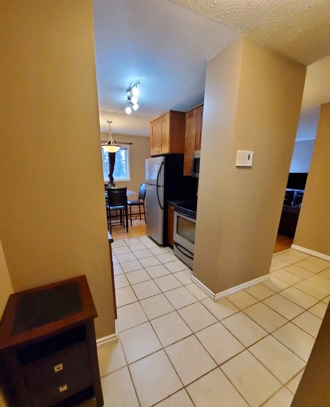 a kitchen with a tiled floor and a