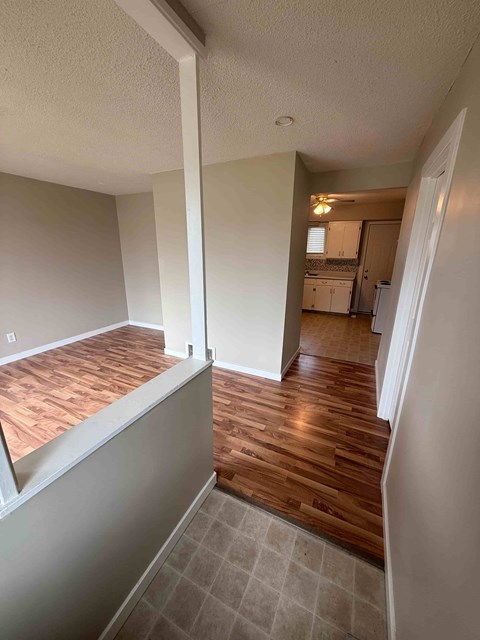 A room with wooden floors and white walls.