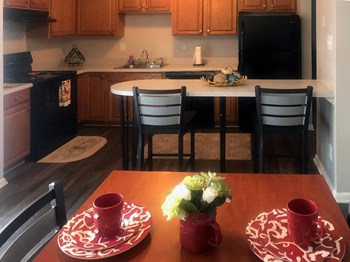 furnished kitchen with table and chairs at River Road Terrace