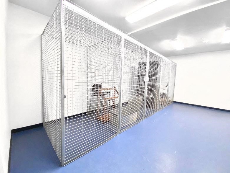 a room with a cage and a table in it