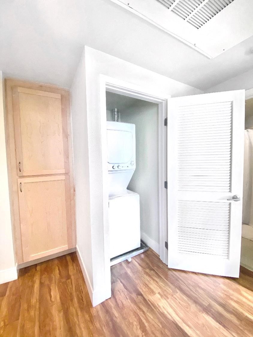 an empty room with a refrigerator and a washing machine