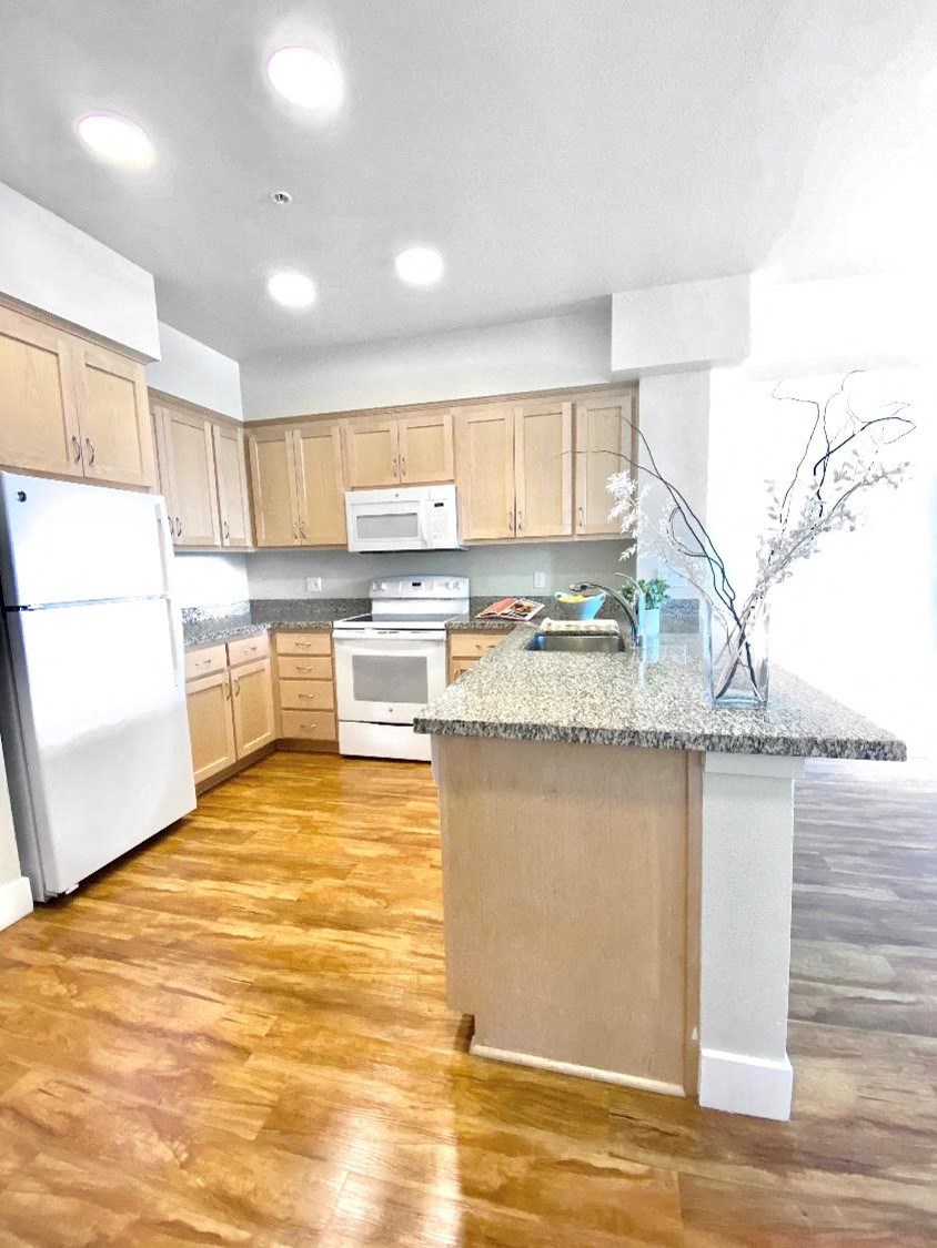 a kitchen with a counter top and a refrigerator