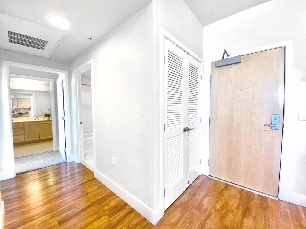 an empty room with a wooden floor and a white door