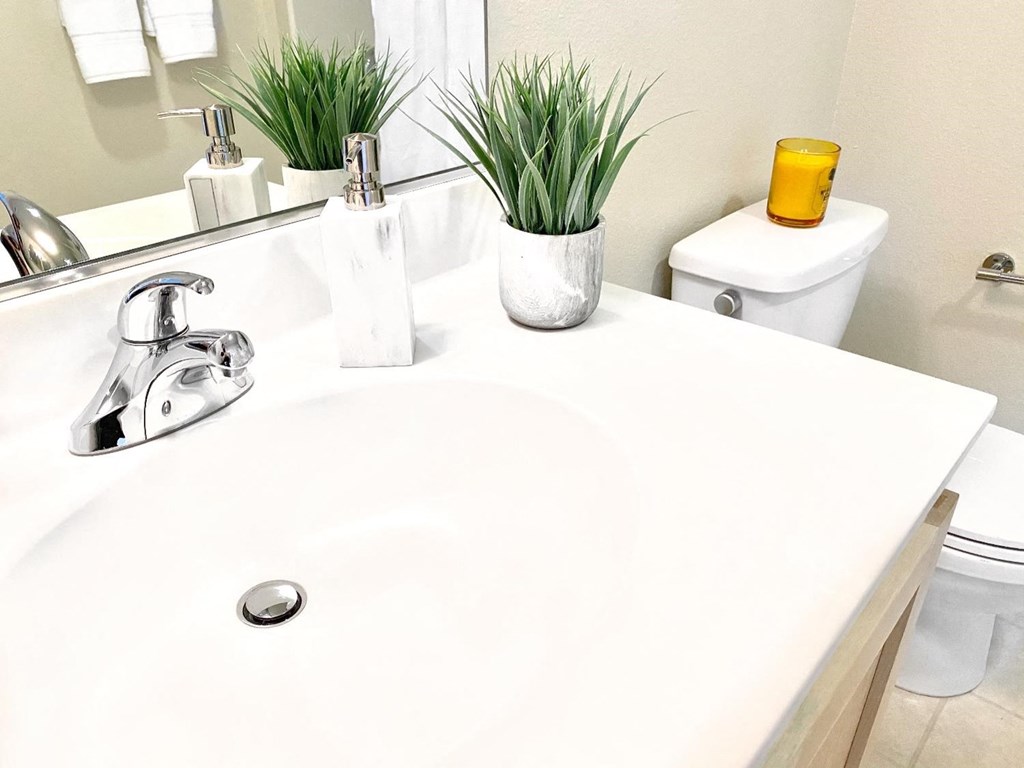 a bathroom with a white sink and a toilet