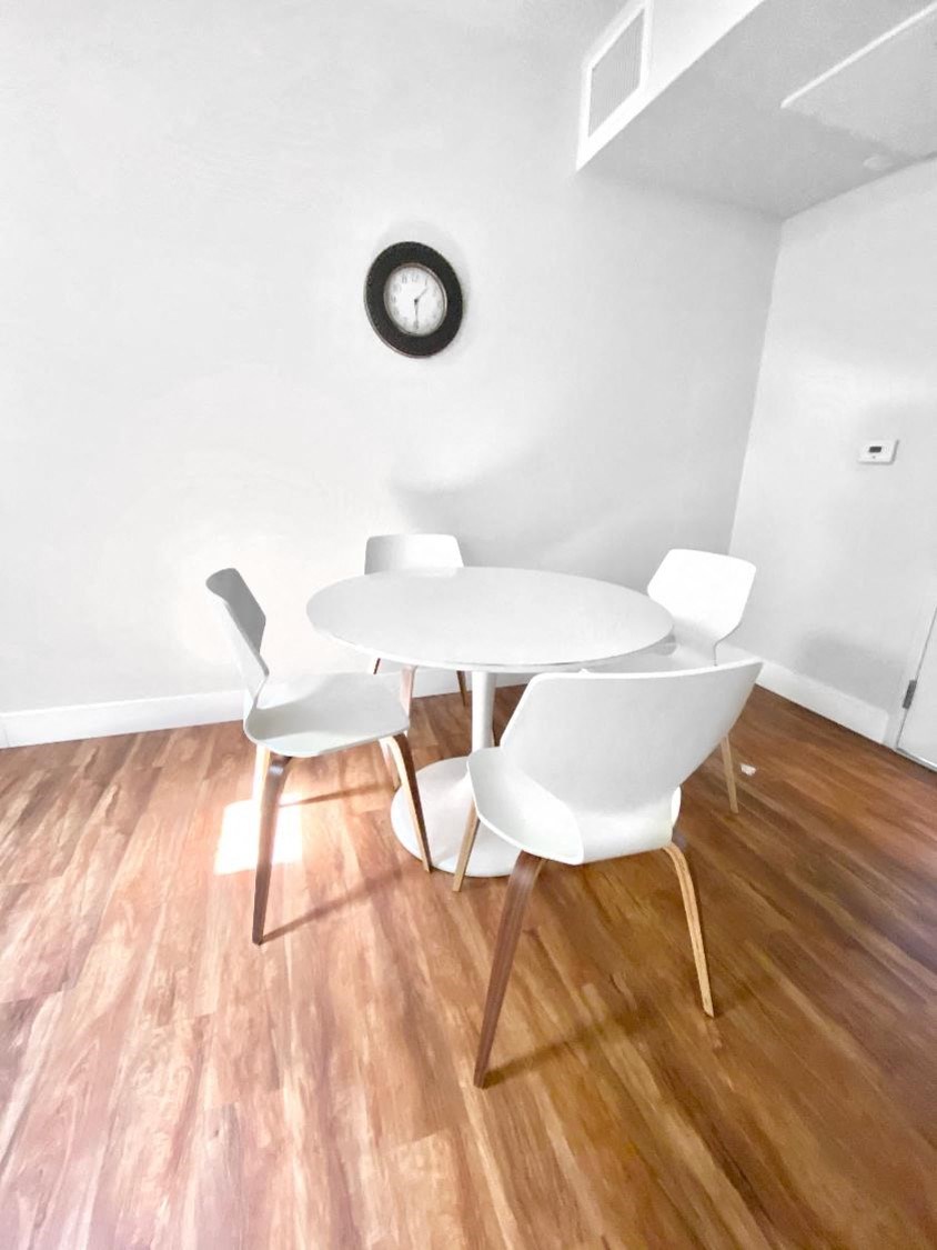 a dining room with a white table and chairs