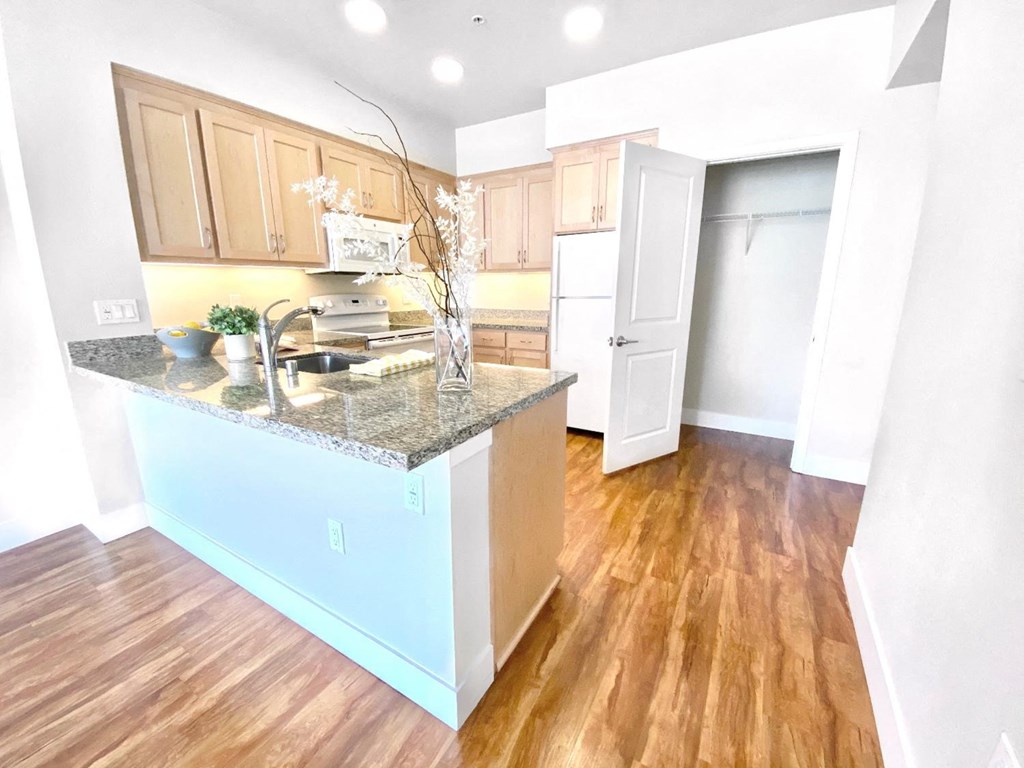 an open kitchen and living room with a counter top