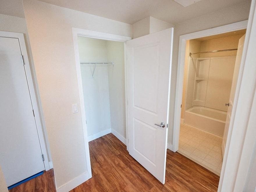 a bathroom with a closet and a white door