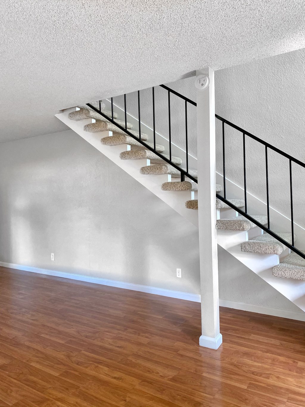 an image of a staircase in a home with wood floors
