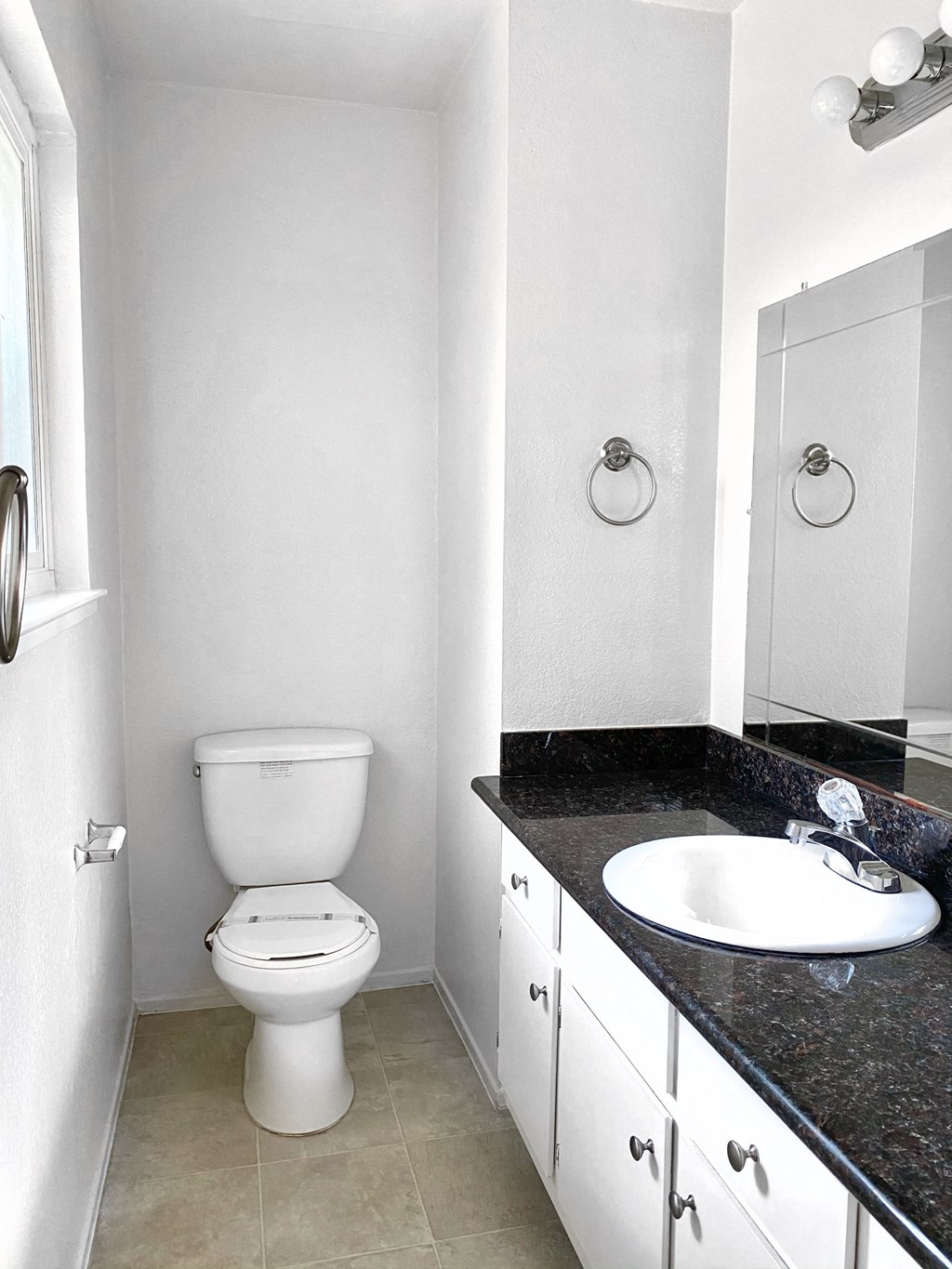 an empty bathroom with a toilet and a sink