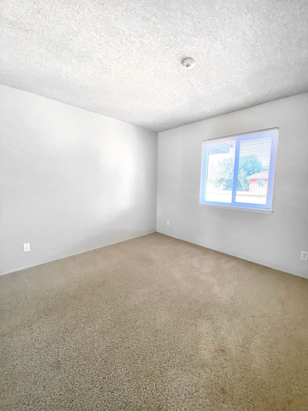 the living room of an empty house with a window