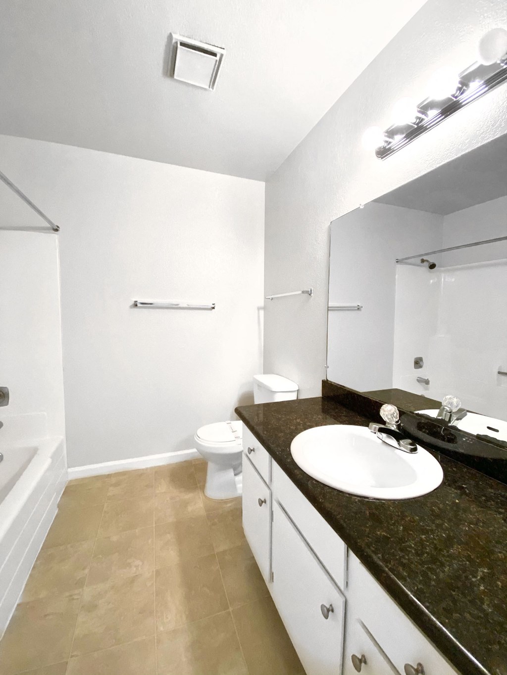 an empty bathroom with a sink and a toilet