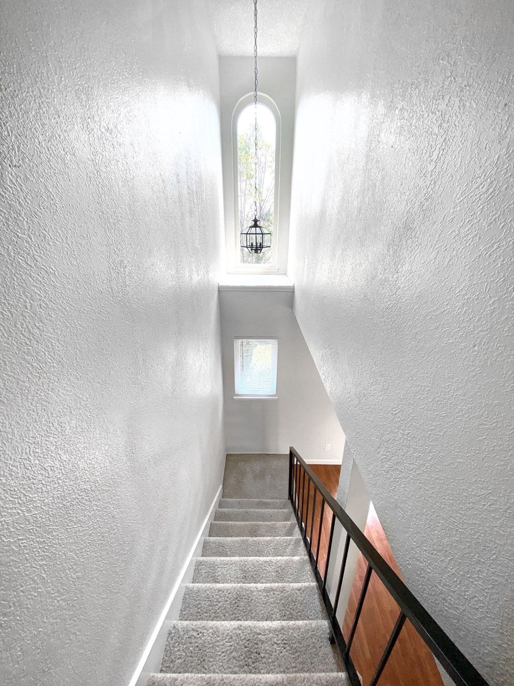 the stairwell of a house with a window and a stairway case with stairs
