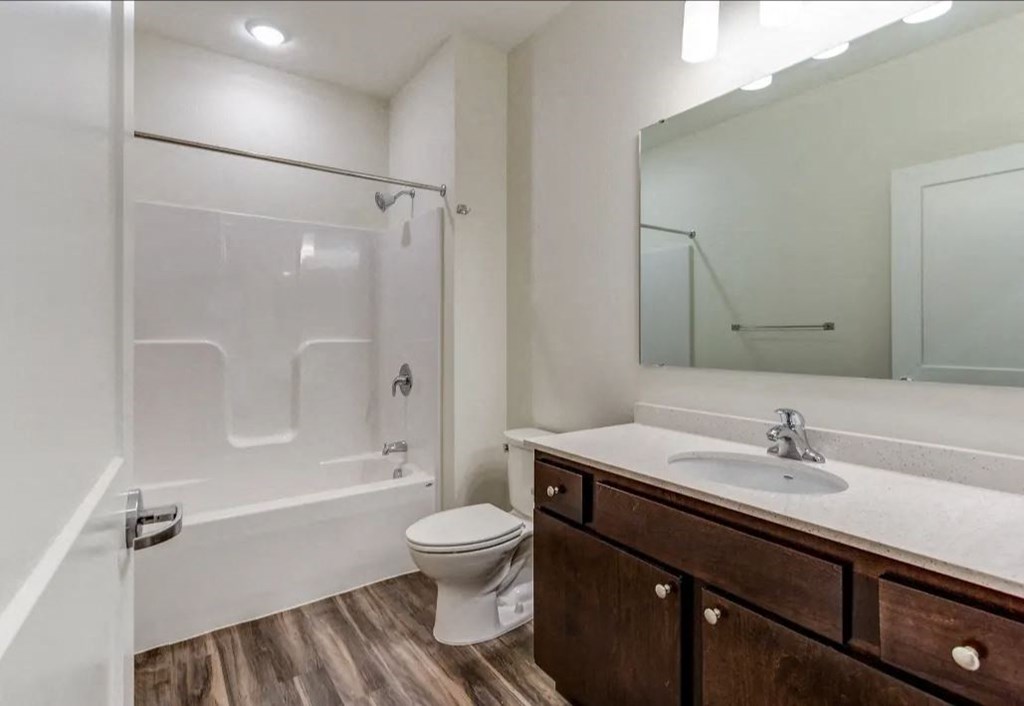 a bathroom with a shower toilet sink and mirror