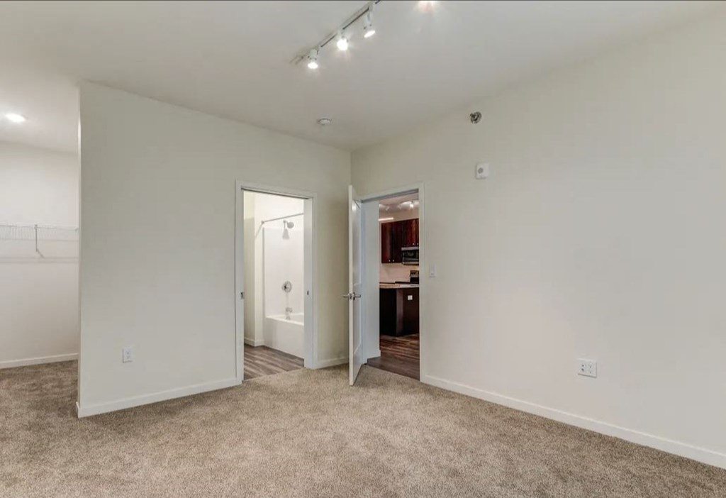 a bedroom with a closet and a door to a bathroom