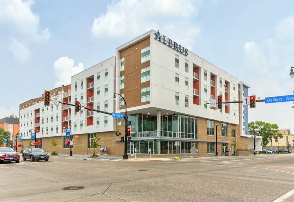 a building at the corner of an intersection with traffic lights