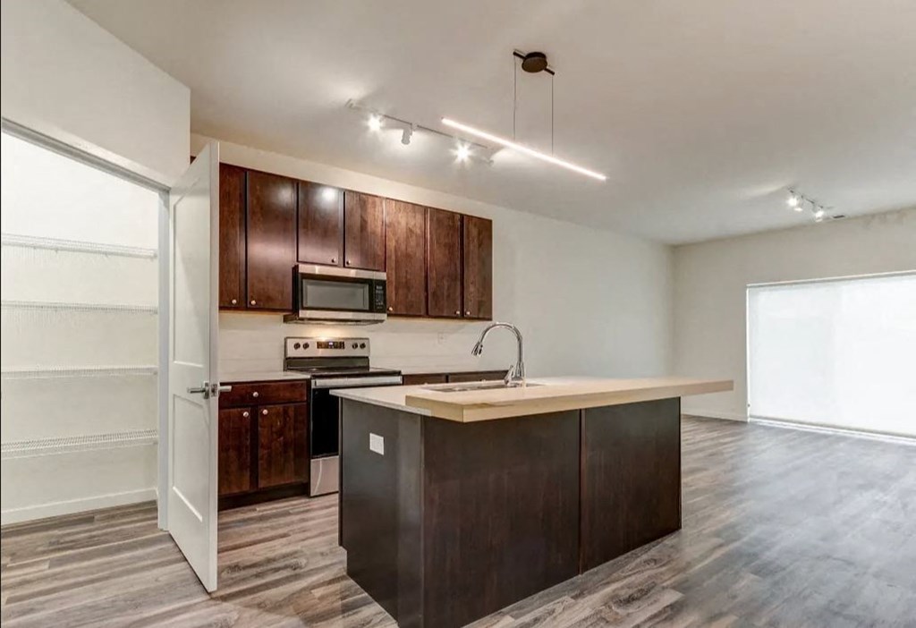 an empty kitchen with wooden cabinets and a counter top