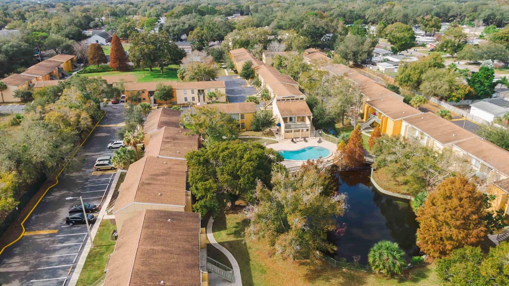 an aerial view of a community with a pool and buildings