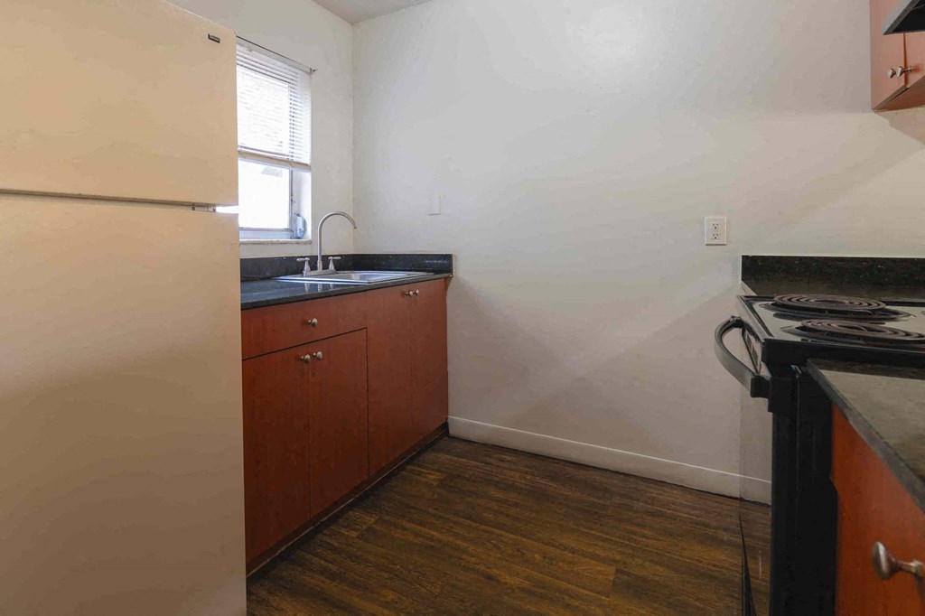 a small kitchen with a sink and a refrigerator