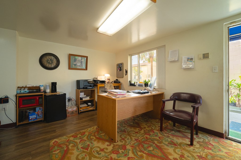 a home office with a desk and a window