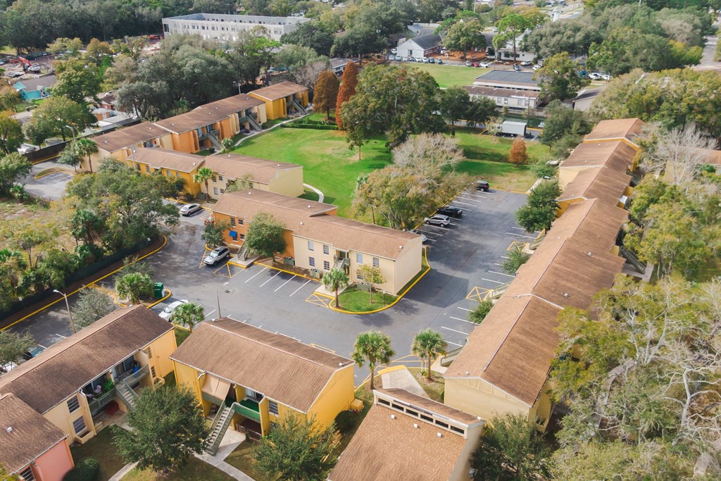 an aerial view of buildings and a parking lot