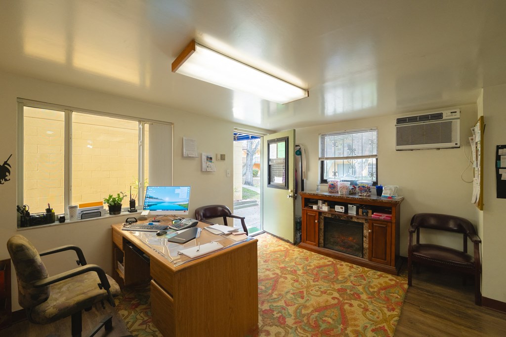 an office with a desk and a fireplace