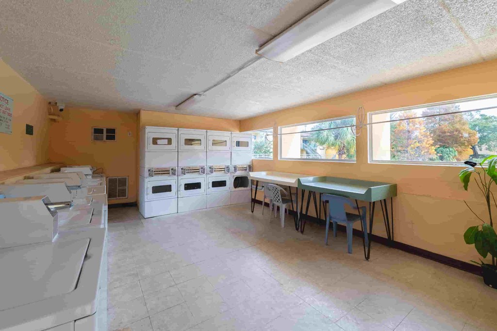 a kitchen with a table with chairs and a counter