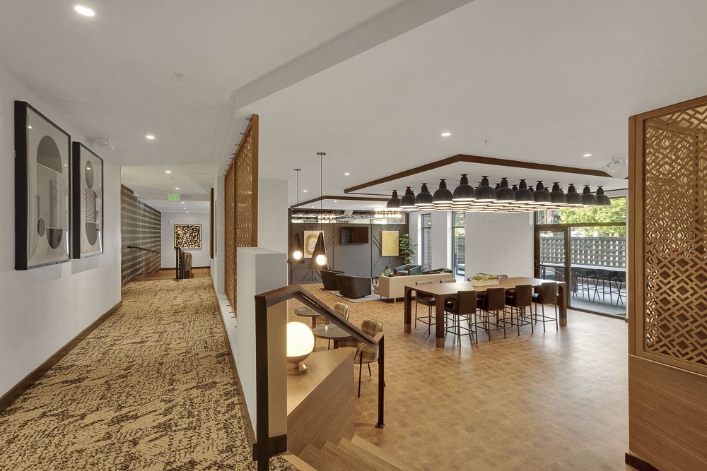 a large living room with a dining room and a staircase