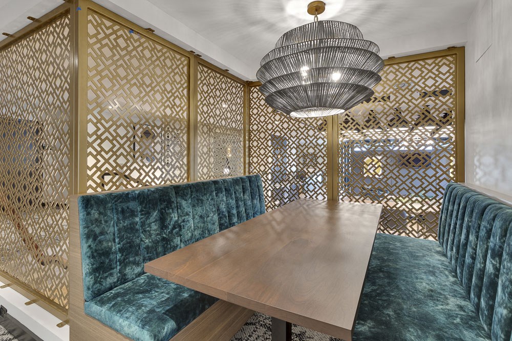 a dining room with a table and chairs and a chandelier