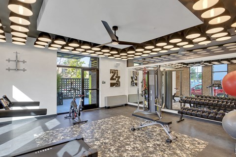 the gym has a view of the pool and gym equipment