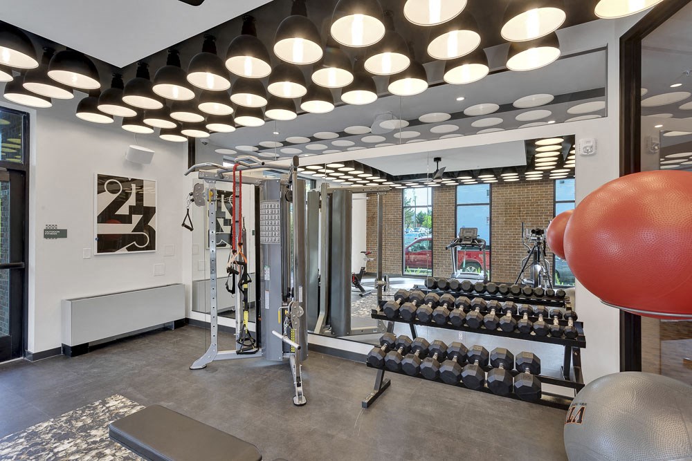 a gym with weights and a red ball on the floor