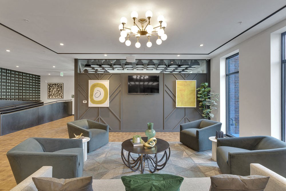 a lobby with couches and chairs and a chandelier
