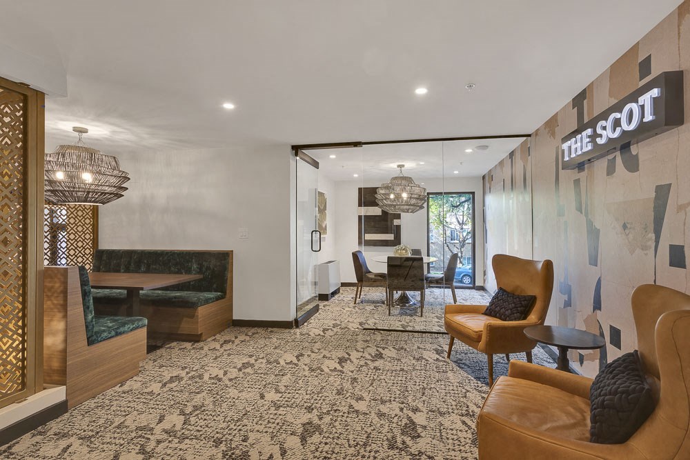 a lobby with couches chairs and a table