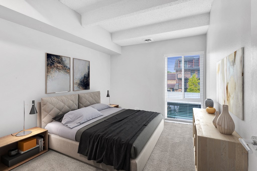 a bedroom with a bed and a large window