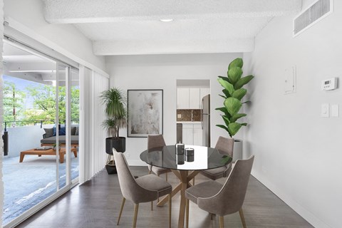 a dining room with a glass table and chairs