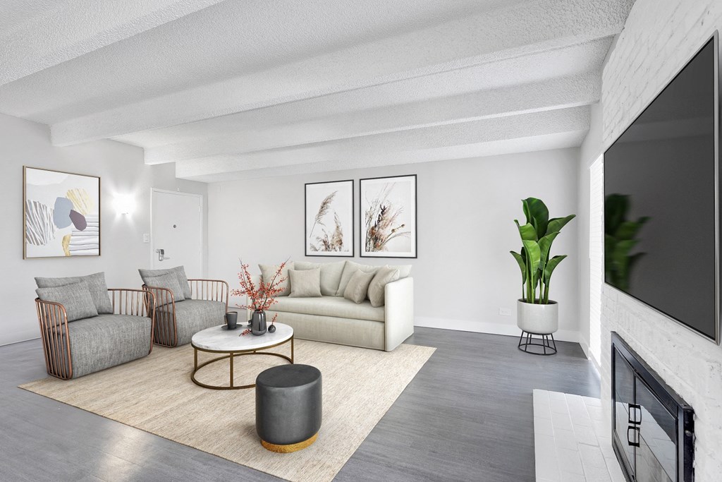 a living room with a couch and a coffee table and a fireplace